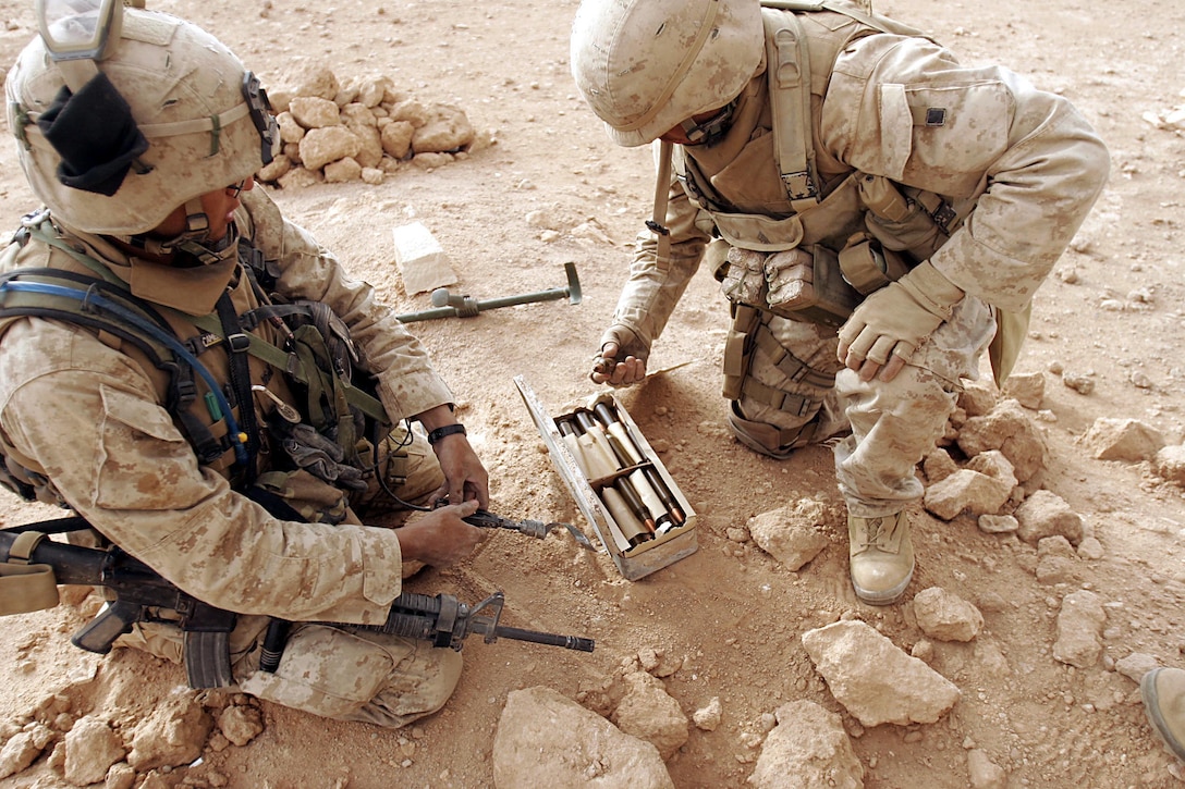 Husaybah, Iraq ( November 7, 2005)--Scouts and combat engineers discovered a huge ammunition cache during Operation Steel Curtain. Jackson dug a few feet into the grave after a metal detector signaled possibly metal there. The possible metal turned out to be 118 boxes of ammo. (Official U. S. Marine Corps photo by Corporal Ken Melton)