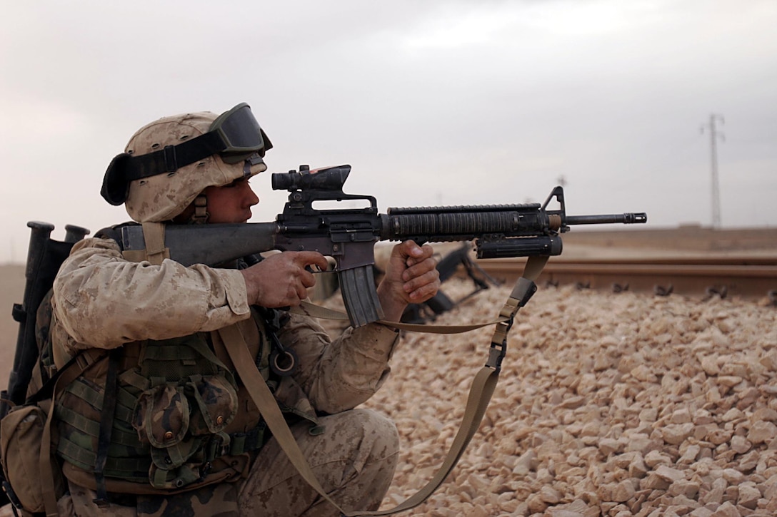 Husaybah, Iraq ( November 7, 2005)-- Scouts with 2nd platoon, 1st LAR engage insurgents during Operation Steel Curtain. A sentry spotted masked men moving in houses across from them while they were providing security for a massive IED underneath a bridge. (Official U. S. Marine Corps photo by Corporal Ken Melton)
