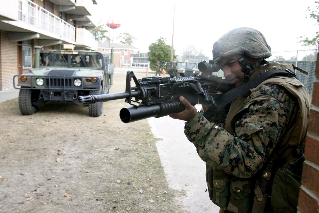 MARINE CORPS BASE CAMP LEJEUNE, N.C. -- Lance Cpl. Deepak Natarajamurthi, an infantryman with Company K, 3rd Battalion, 8th Marine Regiment, peeks out from behind a wall as he provides security for fellow Marines during a security and stability operations training exercise here Dec. 7.  Third Battalion, Eighth Marine Regiment is currently preparing for its second tour of duty in Iraq after having returned from Fallujah nearly four months ago.