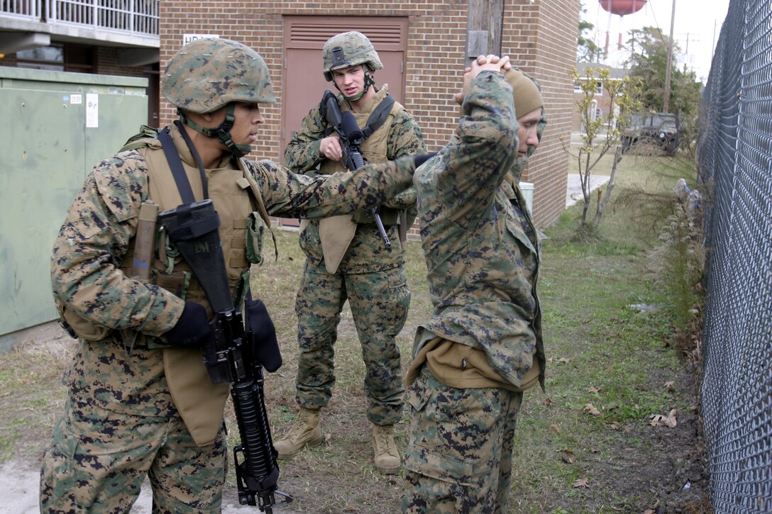 MARINE CORPS BASE CAMP LEJEUNE, N.C. -- A Marine with Company K, 3rd Battalion, 8th Marine Regiment, searches a Marine acting as an Iraqi citizen for contraband during a security and stability operations training exercise here Dec. 7.  Third Battalion, Eighth Marine Regiment is currently preparing for its second tour of duty in Iraq after having returned from Fallujah nearly four months ago.