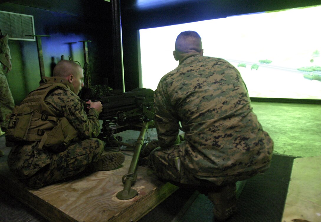MARINE CORPS BASE CAMP LEJEUNE, N.C. -- A Marine with 3rd Battalion, 8th Marine Regiment, practices firing crew-served weapons inside an Indoor Simulation Marksmanship Trainer during a security and stability operations training exercise here Dec. 7.  Third Battalion, Eighth Marine Regiment is currently preparing for its second tour of duty in Iraq after having returned from Fallujah nearly four months ago.