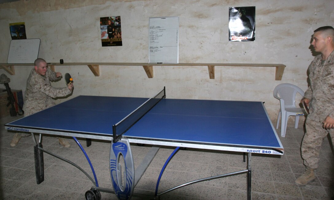 051207-M-2607-003 CAMP FALLUJAH, Iraq -- Private First Class Justin T. Jones and Religious Programmer Kyle C. Mallard play a game of ping pong at the new recreation center aboard Camp Fallujah in 2nd Battalion, 2nd Marine Regiments birthing area on Dec. 7.  The project took a month and a half to complete with many Marines from the battalion helping complete the project.