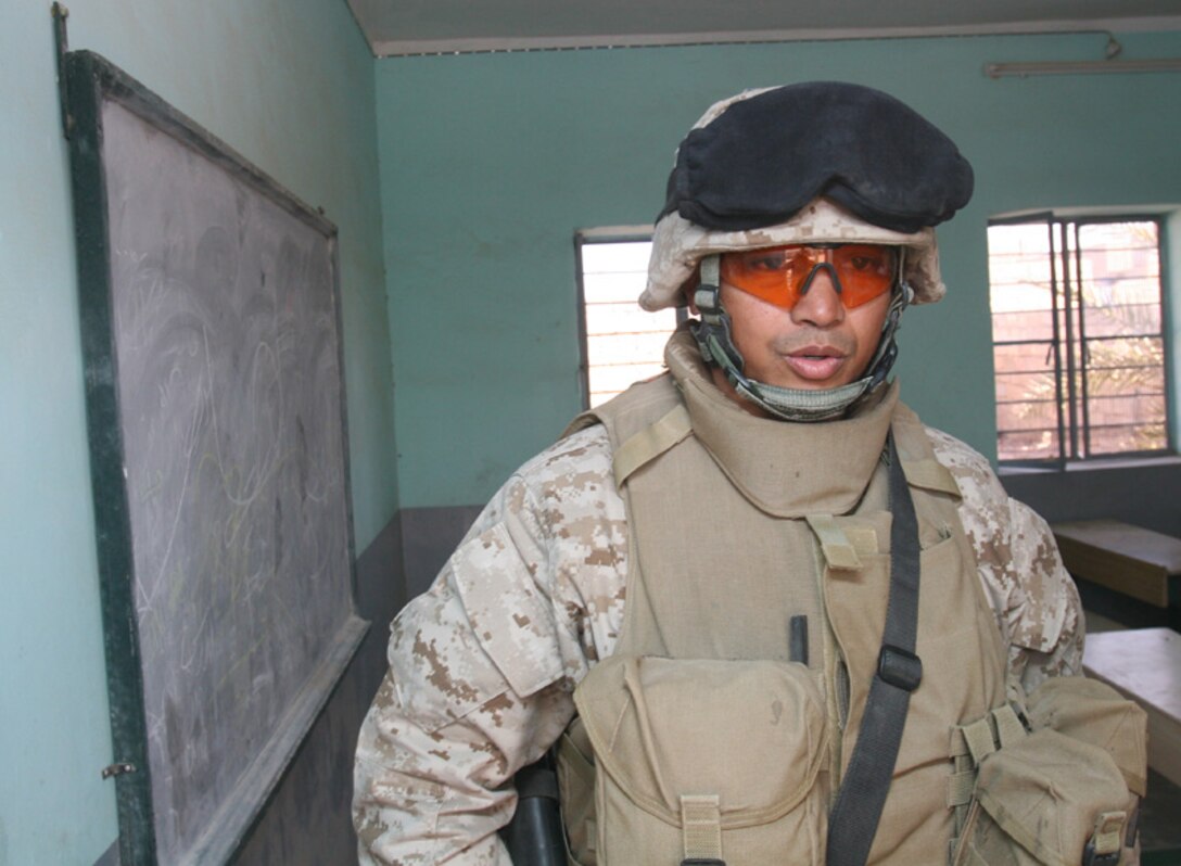 Lt. Col. Robert L. Glover, director, Al Qaim regional Civil-Military Operations Unit, exits a classroom in Husaybah, Iraq. Glover and his squad patrolled today in order to inspect and review schools in accordance with the reconstruction plan outlined by local leadership.
