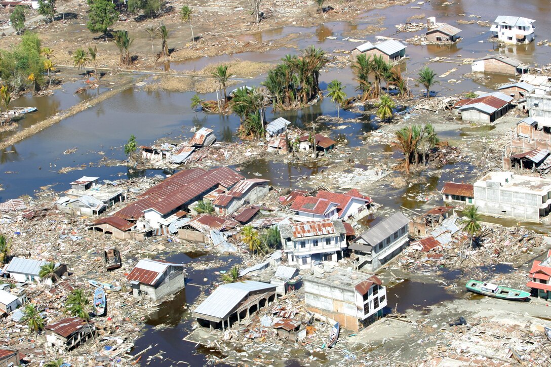 Leveled homes and massive destruction lies motionless below an over flight of a CH 46E Sea Knight helicopter after the country was struck by the Dec. 26 tsunami. Marines and Sailors of the 15th Marine Expeditionary Unit (Special Operations Capable), and USS Bonhomme Richard are in Indonesia to provide food, supplies, and humanitarian aid to people involved in this tragic event.