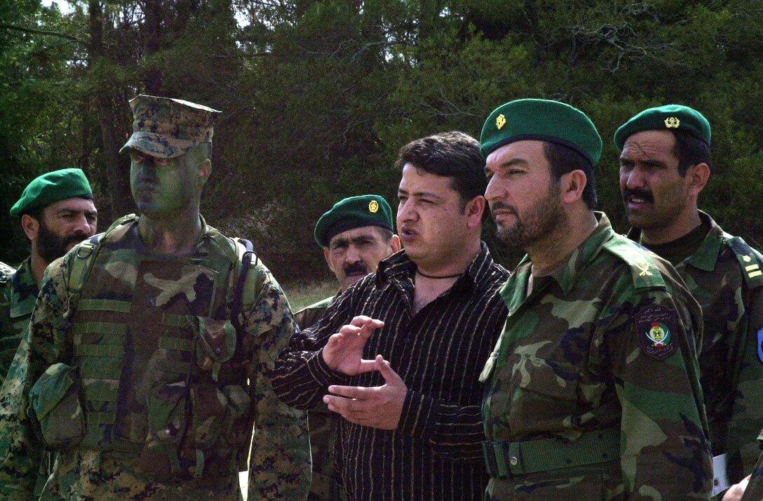 MARINE CORPS BASE CAMP GEIGER, N.C. - Captain Anthony Johnston, A Company commanding officer, explains small-unit tactics to visiting Afghan officers during a visit to the School of Infantry (East) April 8.  The six officers are on a tour of east coast Marine bases to see first hand how the Marine Corps operates on a day-to-day basis. "I am here to see the U.S. Marine Corps training and to take back what I learn to Afghanistan," said Lt. Col. Tamkin Ishaq, battalion commander of the Commando Kandak (battalion). "Your education and training system, as well as your discipline- we are impressed with that." (Official Marine Corps photo by Lance Cpl. Shane Suzuki)