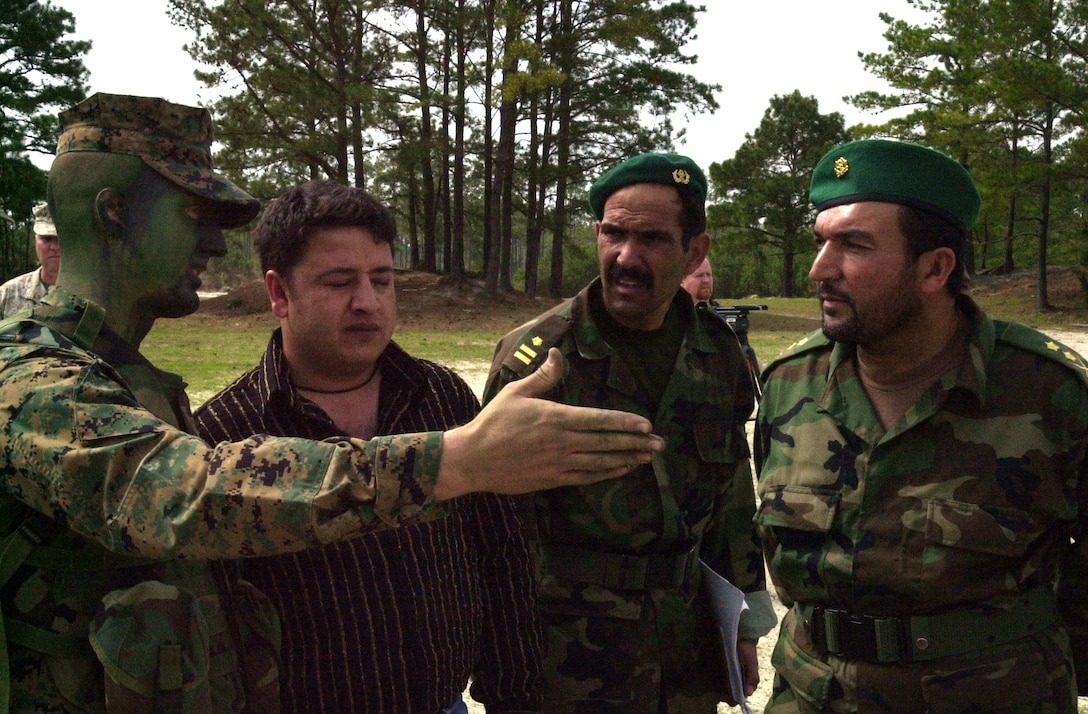 MARINE CORPS BASE CAMP GEIGER, N.C. - Captain Anthony Johnston, A Company commanding officer, explains small-unit tactics to visiting Afghan officers during a visit to the School of Infantry (East) April 8.  The six officers are on a tour of east coast Marine bases to see first hand how the Marine Corps operates on a day-to-day basis. "I am here to see the U.S. Marine Corps training and to take back what I learn to Afghanistan," said Lt. Col. Tamkin Ishaq, battalion commander of the Commando Kandak (battalion). "Your education and training system, as well as your discipline- we are impressed with that." (Official Marine Corps photo by Lance Cpl. Shane Suzuki)