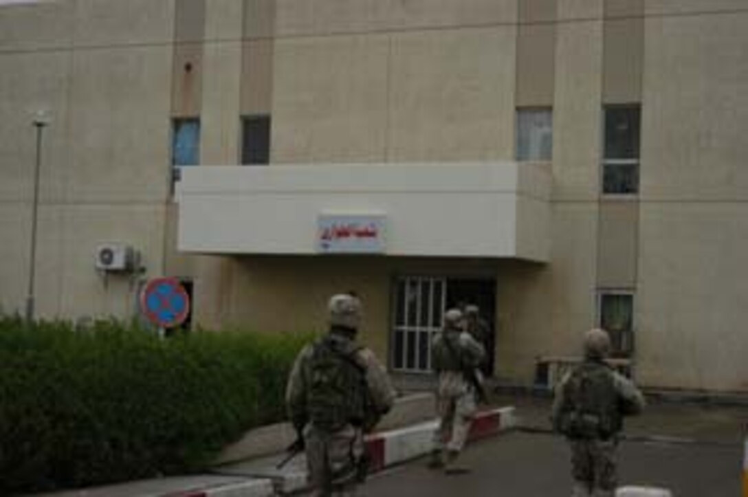 AR, RAMADI, Iraq (March 8, 2005) - Marines enter the Ar Ramadi General Hospital here during an operation. . Marines with Company A, 1st Battalion, 5th Marines joined Company G, 2nd Battalion, 5th Marines in a raid on the hospital in search of weapons caches, insurgents and crimes against humanity. First Battalion, 5th Marines' Human Exploitation Team, Information Operations, the 4th and 5th Civil Affairs Groups and more than 20 Iraqi Security Force Commandos also participated in the mission, which lasted more than four hours. (Official United States Marine Corps photo by Cpl. Tom Sloan)