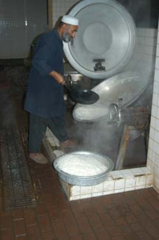AR, RAMADI, Iraq (March 8, 2005) -A cook for the Ar Ramadi General Hospital here prepares rise for the hospital's patients. Food and water was provided to those in the hospital while they were being made to wait several hours. Marines with Company A, 1st Battalion, 5th Marines joined Company G, 2nd Battalion, 5th Marines in a raid on the hospital in search of weapons caches, insurgents and crimes against humanity. First Battalion, 5th Marines' Human Exploitation Team, Information Operations, the 4th and 5th Civil Affairs Groups and more than 20 Iraqi Security Force Commandos also participated in the mission, which lasted more than four hours.  (Official United States Marine Corps photo by Cpl. Tom Sloan)