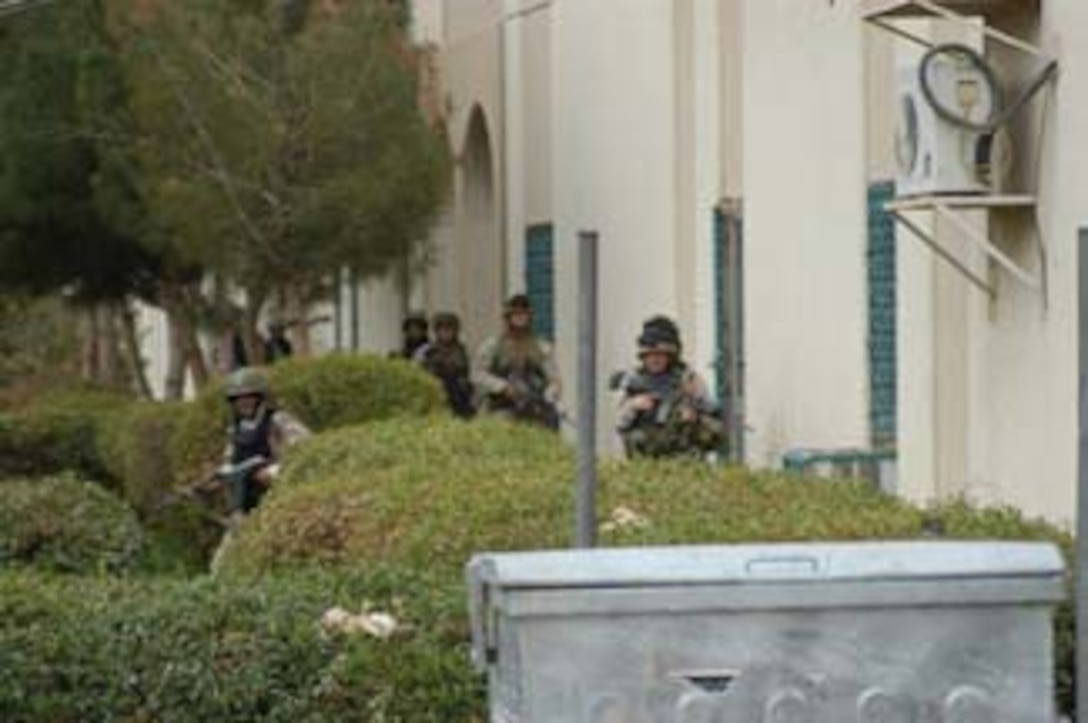AR, RAMADI, Iraq (March 8, 2005) - A squad of Marines secure a side of the Ar Ramadi General Hospital here. Marines with Company A, 1st Battalion, 5th Marines joined Company G, 2nd Battalion, 5th Marines in a raid on the hospital in search of weapons caches, insurgents and crimes against humanity. First Battalion, 5th Marines' Human Exploitation Team, Information Operations, the 4th and 5th Civil Affairs Groups and more than 20 Iraqi Security Force Commandos also participated in the mission, which lasted more than four hours. (Official United States Marine Corps photo by Cpl. Tom Sloan)