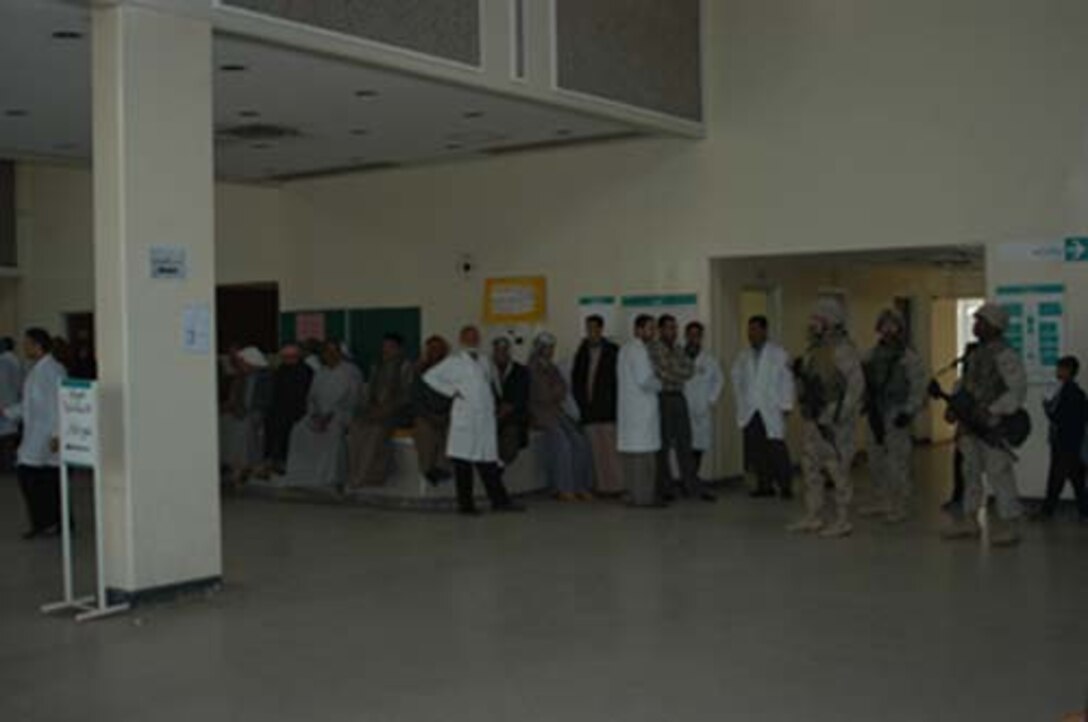 AR, RAMADI, Iraq (March 8, 2005) - Marines with Company A, 1st Battalion, 5th Marines guard doctors, staff, patients and visitors inside the Ar Ramadi General Hospital here. Marines with Company A, 1st Battalion, 5th Marines joined Company G, 2nd Battalion, 5th Marines in a raid on the hospital in search of weapons caches, insurgents and crimes against humanity. First Battalion, 5th Marines' Human Exploitation Team, Information Operations, the 4th and 5th Civil Affairs Groups and more than 20 Iraqi Security Force Commandos also participated in the mission, which lasted more than four hours. (Official United States Marine Corps photo by Cpl. Tom Sloan)