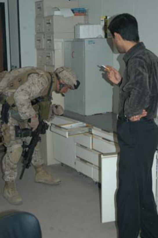 AR, RAMADI, Iraq (March 8, 2005) - Staff Sgt. Cole Daunhauer, 31, of Louisville, Ky., and a platoon sergeant with Company A, 1st Battalion, 5th Marines, searches a lab in the Ar Ramadi General Hospital here. Marines with Company A, 1st Battalion, 5th Marines joined Company G, 2nd Battalion, 5th Marines in a raid on the hospital in search of weapons caches, insurgents and crimes against humanity. First Battalion, 5th Marines' Human Exploitation Team, Information Operations, the 4th and 5th Civil Affairs Groups and more than 20 Iraqi Security Force Commandos also participated in the mission, which lasted more than four hours.  (Official United States Marine Corps photo by Cpl. Tom Sloan)