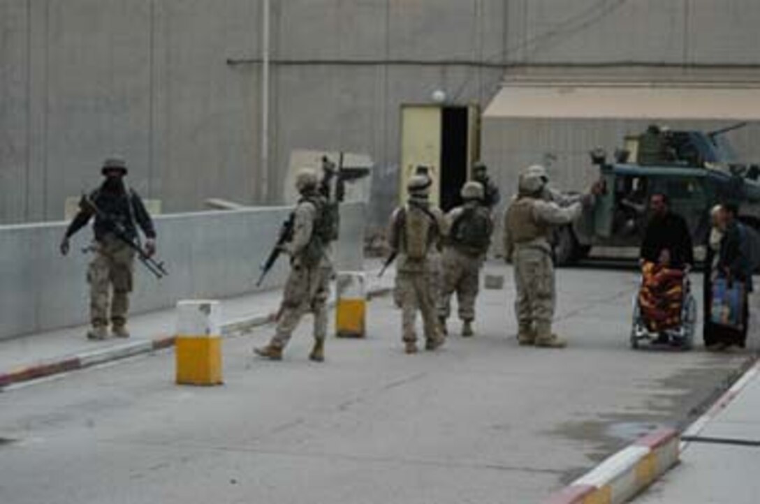 AR, RAMADI, Iraq (March 8, 2005) - Marines with Company A, 1st Battalion, 5th Marines, direct a group of Iraqis, who have a patient in the Ar Ramadi General Hospital here, were to go. Marines with Company A, 1st Battalion, 5th Marines joined Company G, 2nd Battalion, 5th Marines in a raid on the hospital in search of weapons caches, insurgents and crimes against humanity. First Battalion, 5th Marines' Human Exploitation Team, Information Operations, the 4th and 5th Civil Affairs Groups and more than 20 Iraqi Security Force Commandos also participated in the mission, which lasted more than four hours. . (Official United States Marine Corps photo by Cpl. Tom Sloan)