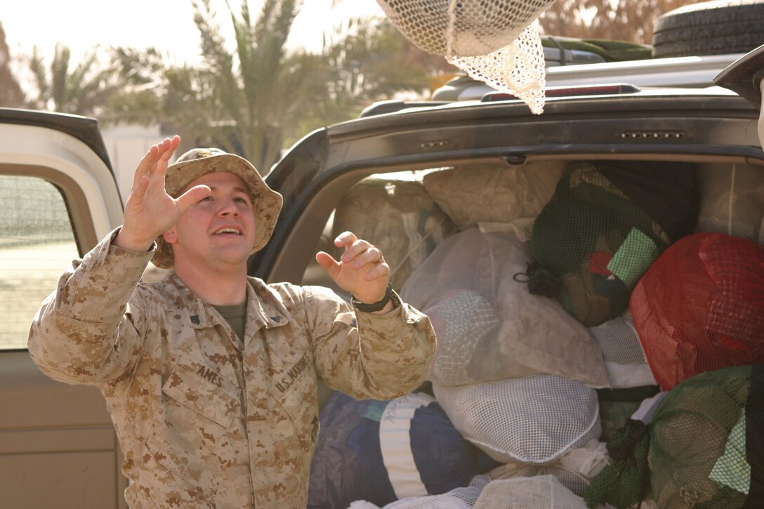 Corporal Steven Bruce Ames II, a 22-year-old Willard Ohio native and personnel administration non-commissioned officer, delivers laundry to the staff billeting here, March 8.  Ames recently arrived here to serve his country in the Global War on Terrorism.  U.S. Marine Corps photo by Sgt. Stephen D'Alessio (RELEASED)