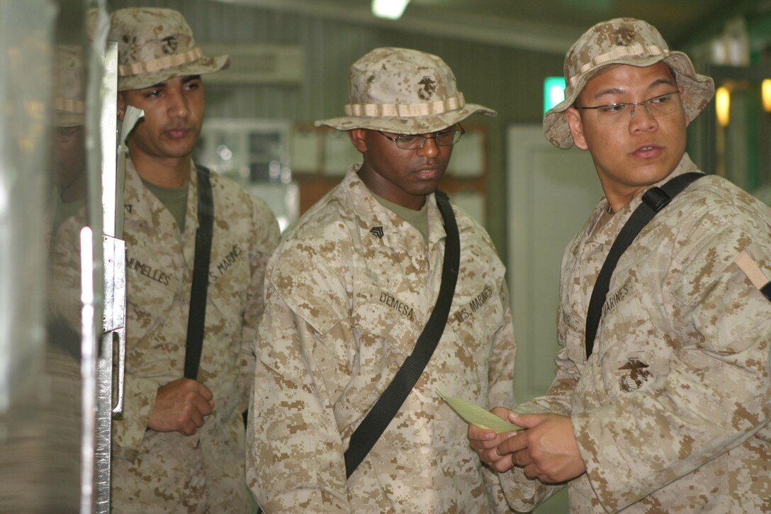 Corporal Ryan Amador, a 22-year-old food services specialist with Headquarters Battalion, 2d Marine Division, makes an inspection of the mess hall's food storage units, March 8, 2005.  Amador's unit recently deployed here for stability and security operations as part of the Global War on Terrorism.  U.S. Marine Corps photo by Sgt. Stephen D'Alessio (RELEASED)