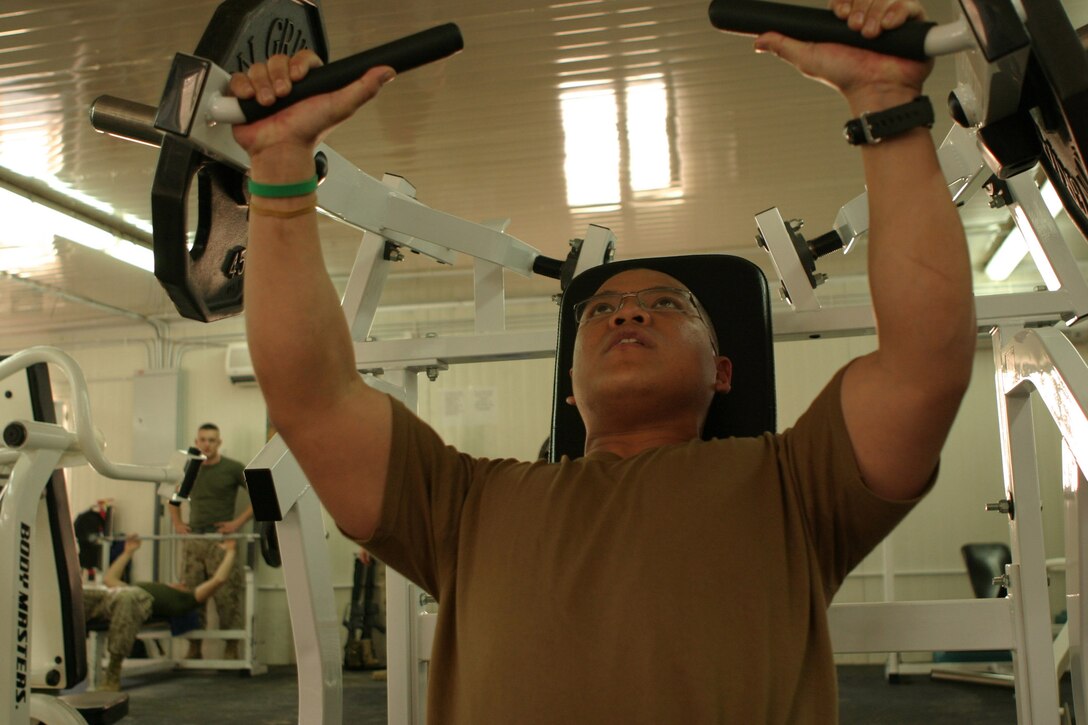 Corporal Ryan Amador, a 22-year-old food services specialist with Headquarters Battalion, 2d Marine Division, gets his 'sweat on' during an afternoon break, March 8, 2005, at the Camp Blue Diamond gymnasium.  Amador's unit recently deployed here for stability and security operations as part of the Global War on Terrorism.  U.S. Marine Corps photo by Sgt. Stephen D'Alessio (RELEASED)