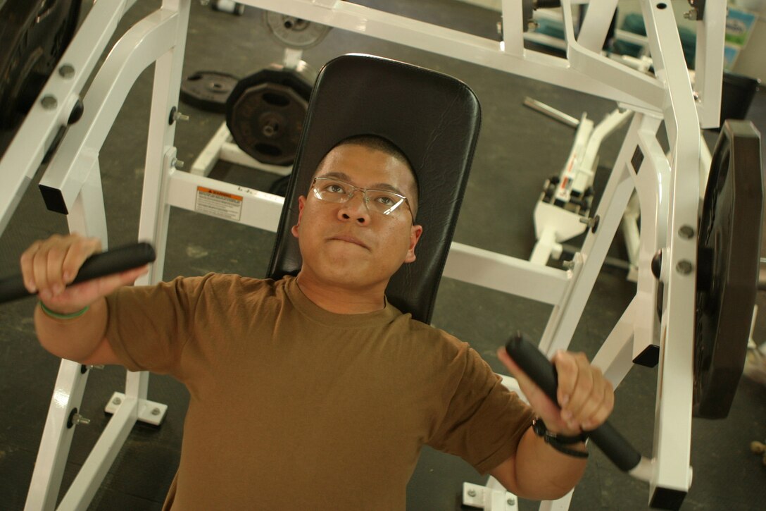Corporal Ryan Amador, a 22-year-old food services specialist with Headquarters Battalion, 2d Marine Division, gets his 'sweat on' during an afternoon break, March 8, 2005, at the Camp Blue Diamond gymnasium.  Amador's unit recently deployed here for stability and security operations as part of the Global War on Terrorism.  U.S. Marine Corps photo by Sgt. Stephen D'Alessio (RELEASED)