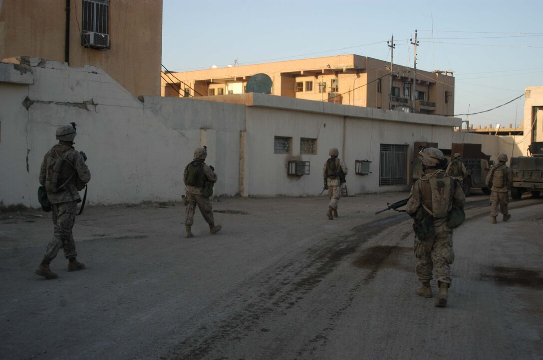 AR RAMADI, Iraq (April 8, 2005) -Marines with 1st Squad, 4th Platoon, Company A, 1st Battalion, 5th Marine Regiment, leave the confines of the Government Center, which is an observation post, and head toward the city's marketplace to conduct a patrol. Leathernecks with 4th Platoon, Company A, 1st Battalion, 5th Marines, patrolled the marketplace in an effort to familiarize themselves with their area of operations and determine how the local Iraqis feel about their presence in the area. The Marines also handed out positive and anti-insurgent propaganda to the Iraqis and searched for insurgents and things out of the ordinary during the two-hour operation. Photo by Cpl. Tom Sloan