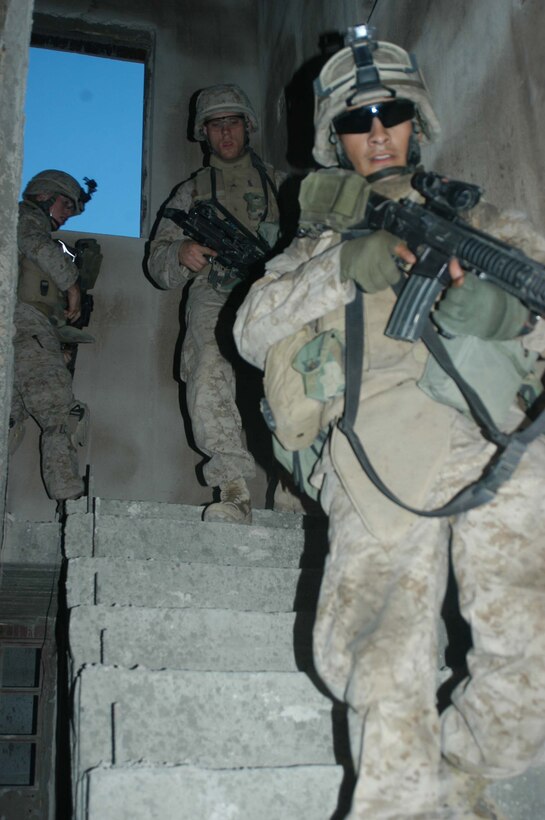 AR RAMADI, Iraq (April 8, 2005) -Lance Cpl. Ismael Benavides, rifleman, 1st Squad, 4th Platoon, Company A, 1st Battalion, 5th Marine Regiment, leads the way down a flight of stairs in an abandoned building he and his Marines used for an over watch during a patrol of the of the marketplace here. The 18-year-old from Los Angeles and other warriors with 4th Platoon, Company A, 1st Battalion, 5th Marines, patrolled the marketplace in an effort to familiarize themselves with their area of operations and determine how the local Iraqis feel about their presence in the area. The Marines also handed out positive and anti-insurgent propaganda to the Iraqis and searched for insurgents and things out of the ordinary during the two-hour operation. Photo by Cpl. Tom Sloan