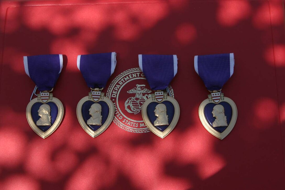 CAMP FALLUJAH, IRAQ - Captain William G. Rayne, Sgt. Jorge H. Herrera, Lance Cpl. Joshua C. Landis and Lance Cpl. Curt L. Smith all received their Purple Heart Medals in a ceremony here May 8.  The Marines were involved in a rocket propelled grenade attack on their building in the middle of the night.  Official U.S. Marine Corps photo by Lance Cpl. Athanasios L. Genos