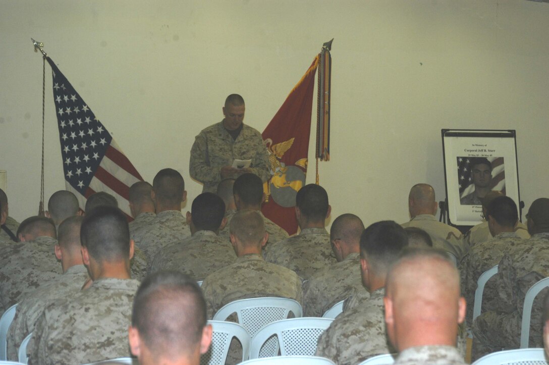 CAMP RAMADI Ar Ramadi, Iraq (June 7, 2005) - Navy lieutenant Aaron T. Miller, the chaplain for 1st Battalion, 5th Marine Regiment, delivers the invocation during a memorial ceremony here for Cpl. Jeff B. Starr. The late Company B warrior was killed May 30, Memorial Day, by small arms fire while conducting operations against enemy forces in this city. Miller, a 32-year-old from Redlands, Calif., gave a message that focused on the value of life and the price Starr paid. Scores of Marines from the infantry battalion attended the ceremony to honor their comrade who paid the ultimate price while fighting terror on the urban battlefield. Photo by: Cpl. Tom Sloan