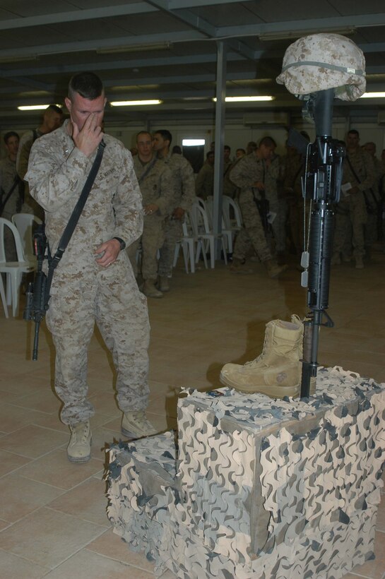 CAMP RAMADI Ar Ramadi, Iraq (June 7, 2005) - Lieutenant Colonel Eric M. Smith, commander of 1st Battalion, 5th Marine Regiment, stands in front of Cpl. Jeff B. Starr's monument and pays his respects during a memorial ceremony here. The late Company B warrior was killed May 30, Memorial Day, by small arms fire while conducting operations against enemy forces in this city. Smith, a 39-year-old from Plano, Texas, and scores of Marines from the infantry battalion attended the ceremony to honor their comrade who paid the ultimate price while fighting terror on the urban battlefield. Photo by: Cpl. Tom Sloan
