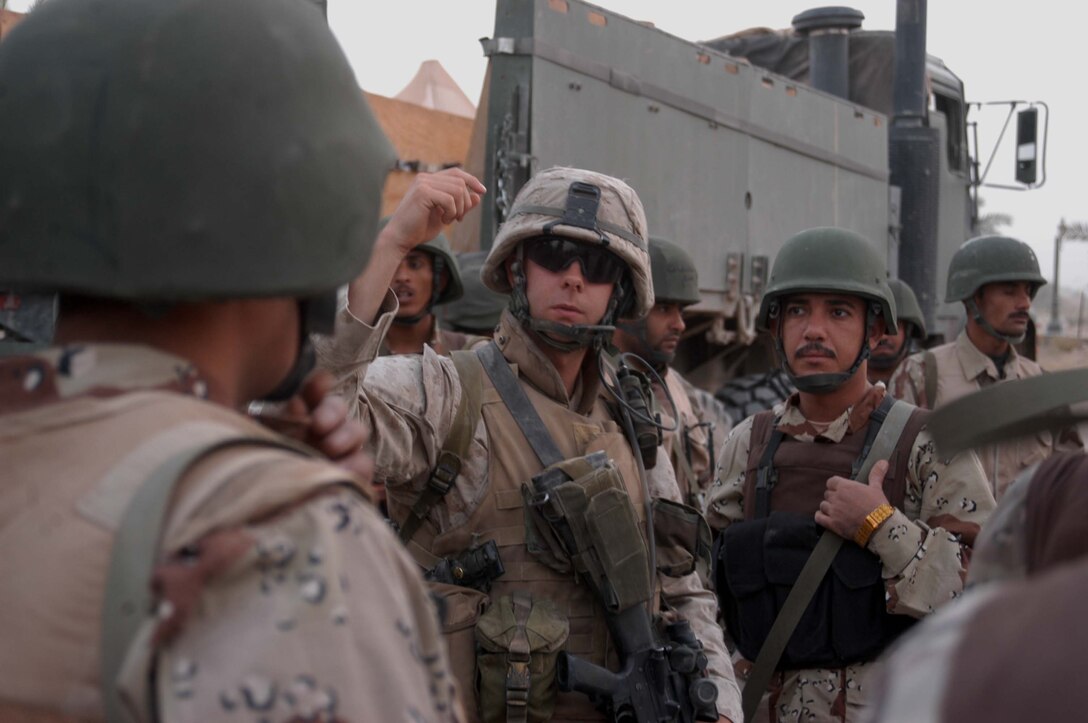 CAMP HURRICANE POINT Ar Ramadi, Iraq (Aug. 8, 2005) - Sergeant Daniel A. Cochran, a rifleman and team leader with the Combined Action Platoon(CAP), Company B, 1st Battalion, 5th Marine Regiment, briefs members of the Iraqi Security Forces at the camp here Aug. 8 prior to conducting a security and stabilization operation in the Al Anbar capital in support of Operation Iraqi Freedom. Twenty-one-year-old Cochran from Unionville, Va., and fellow CAP Marines train new members of the ISF and employ them on Ramadi's urban battlefield to help secure the city from terrorism. The Marines are letting the ISF carry more of the operational workload because their tactics are improving. Iraqi Security Forces are even leading their own foot patrols. Photo by: Cpl. Tom Sloan