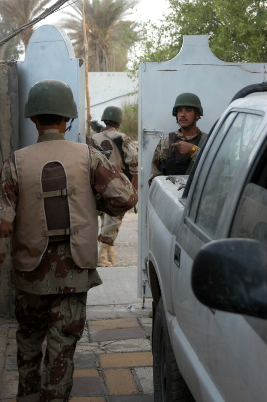 AR RAMADI, Iraq (Aug. 8, 2005) -A member of the Iraqi Security Forces gets accountability of his men after searching a residence during a mission in the city here Aug. 8. Marines with the Combined Action Platoon(CAP), Company B, 1st Battalion, 5th Marine Regiment, support Operation Iraqi Freedom by training new members of the ISF and employing them on Ramadi's urban battlefield to help secure the city from terrorism. The Marines are letting the ISF carry more of the operational workload because their tactics are improving. Iraqi Security Forces are even leading their own foot patrols. Photo by: Cpl. Tom Sloan