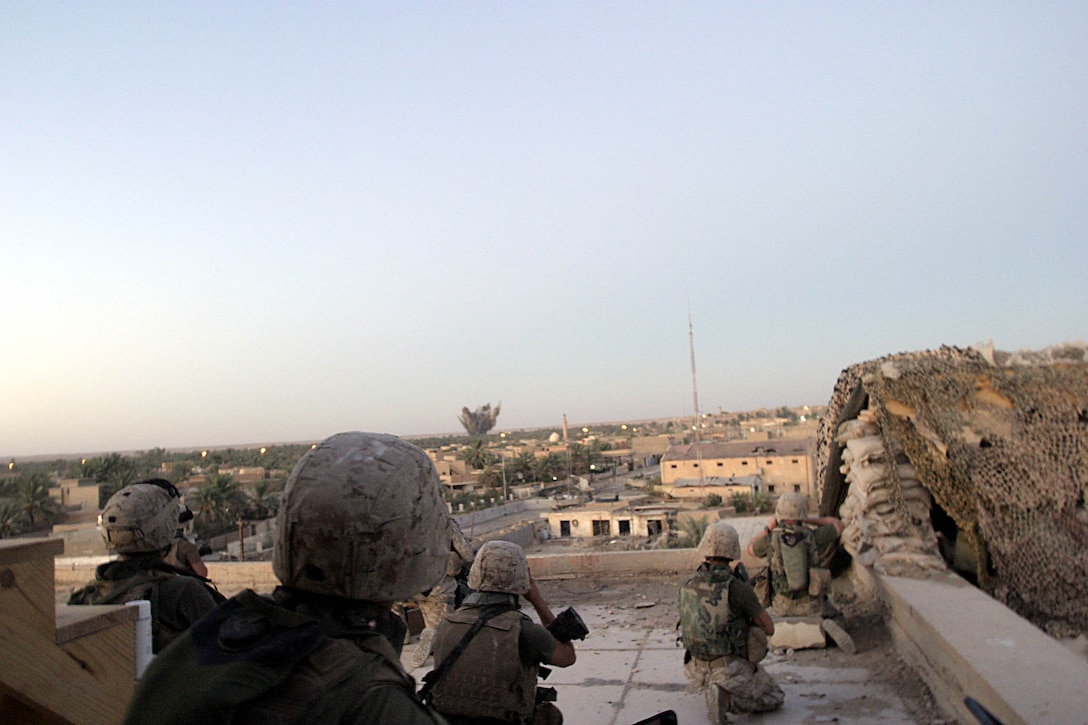 Hit, Iraq (September 8, 2005)-- Marines with Company "I", 3rd Battalion, 25th Marines watch as bomb called in by Sgt. Aaron J. Maxwell, a tactical air control party chief and his team successfully hits its target.  (Official USMC Photo by Corporal Ken Melton)