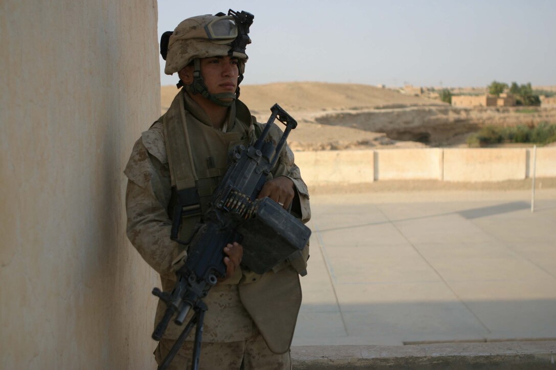 KHAFFAJIYAH, Iraq - Lance Corporal Pedro L. Rangel provides security during an operation to clear insurgents from the city here. Rangel, a field radio operator with Regimental Combat Team 2 informs local Iraqis when coalition forces enter a city letting them know how they can stay safe. Rangel also meets with inhabitants of the city face to face handing out information pamphlets and collecting information that could lead to the whereabouts of insurgents. Official U.S. Marine Corps photo by Sgt. Ryan S. Scranton