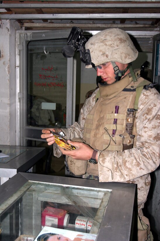 AR RAMADI, Iraq (December 8, 2005) - A Marine with 4th Platoon, Company I, 3rd Battalion, 7th Marine Regiment, searches a store for hidden illegal weapons during Operation Skinner Dec. 8. Photo by Cpl. Shane Suzuki