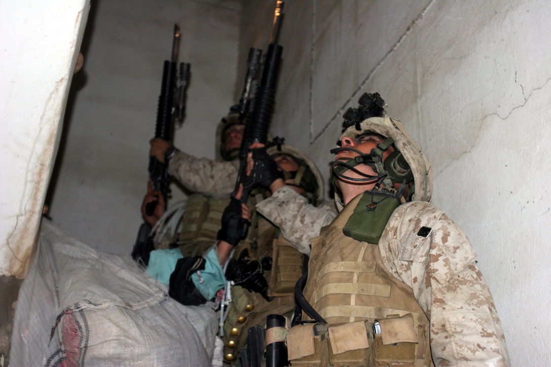 AR RAMADI, Iraq (December 8, 2005) - Marines with 4th Platoon, Company I, 3rd Battalion, 7th Marine Regiment, search a store for hidden illegal weapons during Operation Skinner Dec. 8. Photo by Cpl. Shane Suzuki