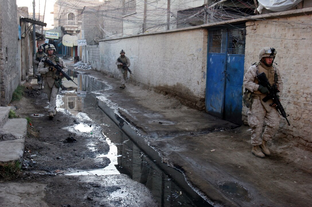 AR RAMADI, Iraq (December 8, 2005) - Marines with 4th Platoon, Company I, 3rd Battalion, 7th Marine Regiment, patrol through the streets of the market district of Ar Ramadi during Operation Skinner Dec. 8. Photo by Cpl. Shane Suzuki