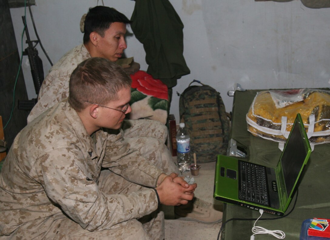 Cpl. Jason Johnson, a 23-year-old Auburn, Wash., native and field radio operator with 6th Civil Affairs Group watches a movie during a brief period of downtime in Husaybah, Iraq. Johnson is part of 6th CAG's Civil-Military Operations Center, the purpose of which is to facilitate reconstruction in the war-torn Al Qaim region. Johnson and the rest of his unit deployed to Iraq August 2005.