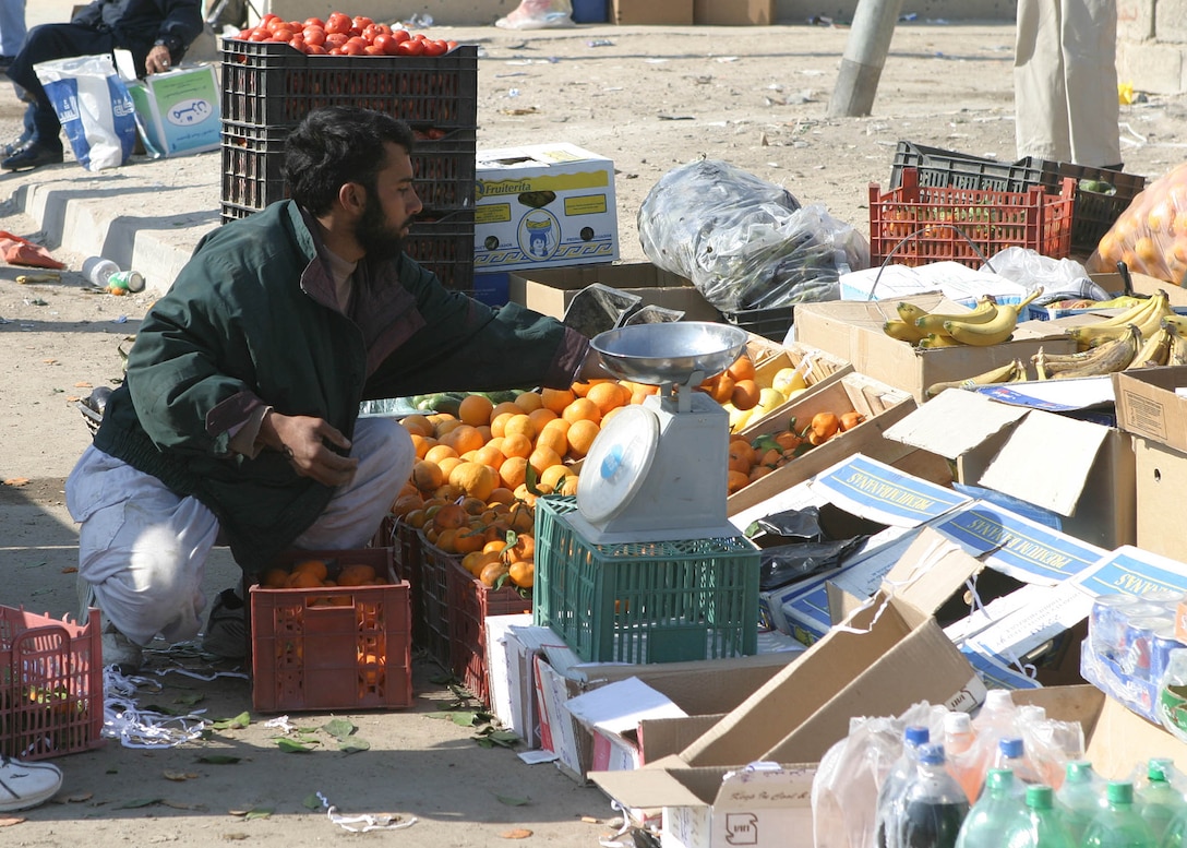 A local Iraqi sells fruit at one of the first local markets created since residents returned to Fallujah Dec. 23.