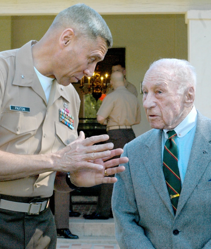 Brig. Gen. John M. Paxton Jr., commanding general, Marine Corps Recruit Depot San Diego and the Western Recruiting Region, visits with retired Lt. Gen. Victor H. Krulak in his back yard April 1. Lt. Gen. Krulak fought in World War II as a lieutenant, and he received the Legion of Merit with a combat distinguishing device and the Bronze Star for his heroic actions on Okinawa, Japan. The Okinawa campaign took place from April to June 1945 and was the largest sea, land and air battle in history at the time. Paxton invited Lt. Gen. Krulak and other Okinawa veterans to the depot for Company C's graduation. Pfc. Carlos Chavez/Chevron