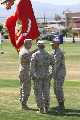 Lt. Col. Roger B. Turner, incom,ing commanding officer of 3rd Battalion, 7th Marines, returns the battalion's battle color to Sgt. Maj. Walter H. Kilgore, battalion sergeant major, as outgoing commanding officer, Lt. Col. Matthew A. Lopez, stands at attention April 8.
