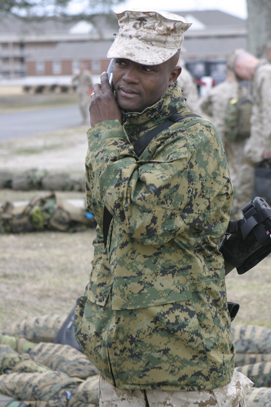 MARINE CORPS BASE CAMP LEJEUNE, N.C. - A Marine with 1st Battalion, 6th Marine Regiment says goodbye to loved ones over the phone before boarding a bus headed for Marine Corps Air Station Cherry Point, N.C.   The unit will fly out from there with a final destination of Fallujah, Iraq, where they will conduct security and stability operations and help rebuild the city's infrastructure.