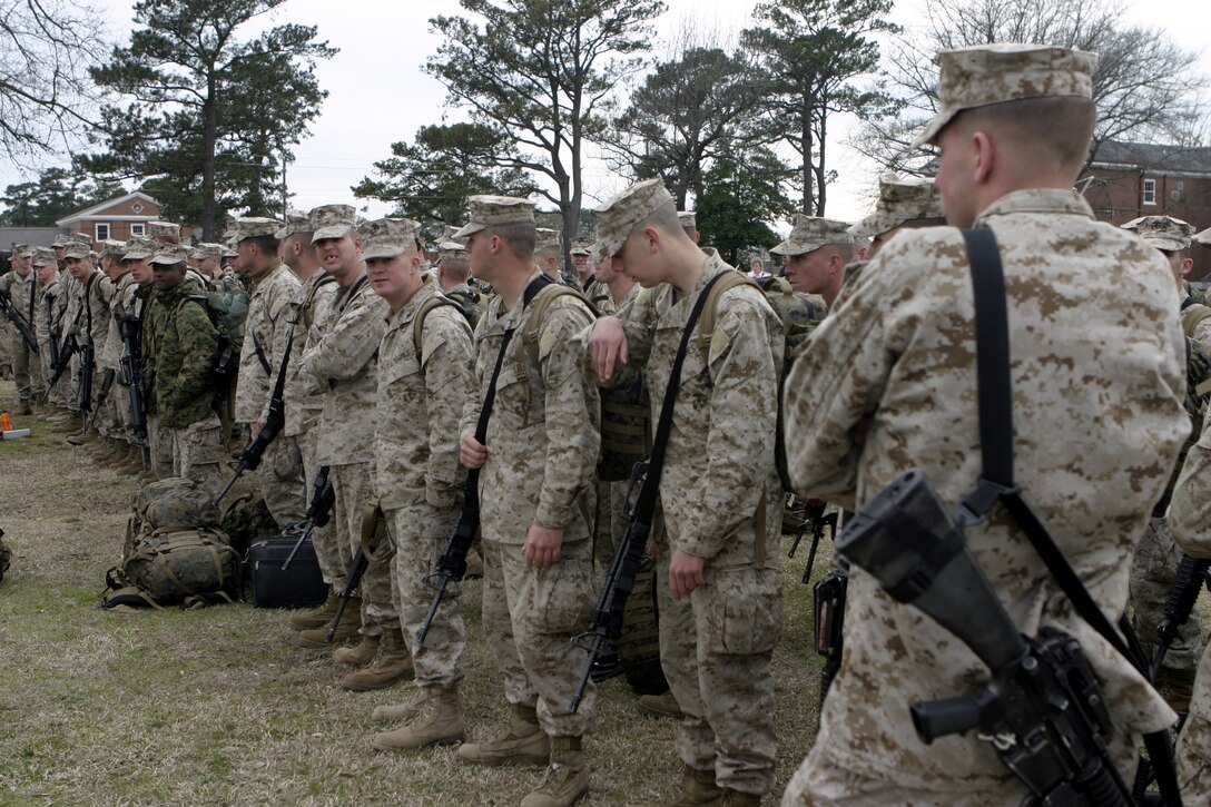 MARINE CORPS BASE CAMP LEJEUNE, N.C. - Marines with 1st Battalion, 6th Marine Regiment stand in formation as they wait to board buses headed for Marine Corps Air Station Cherry Point, N.C.   The unit will fly out from there with a final destination of Fallujah, Iraq, where they will conduct security and stability operations and help rebuild the city's infrastructure.