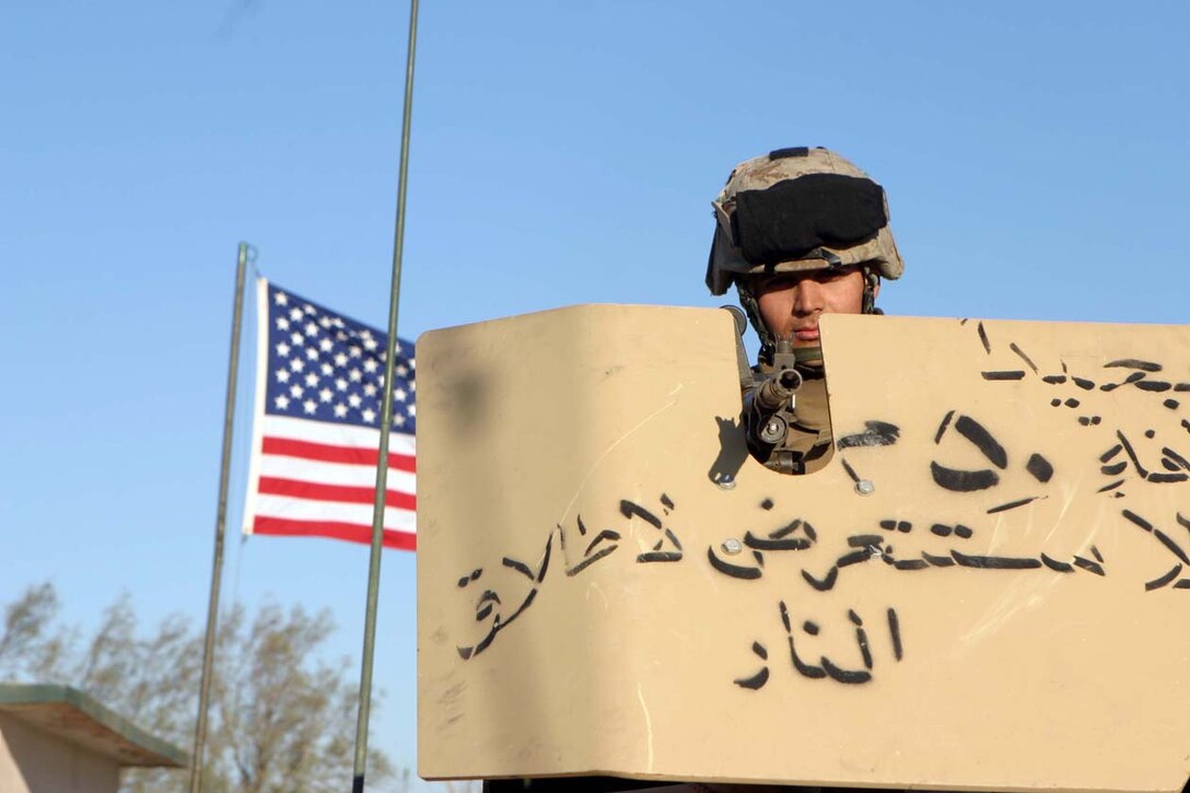 CAMP FALLUJAH, IRAQ – Lance Cpl. Vicente Figueroa, the battalion commander’s machine gunner, sits atop the vehicle in the turret with his M240G medium machine gun.