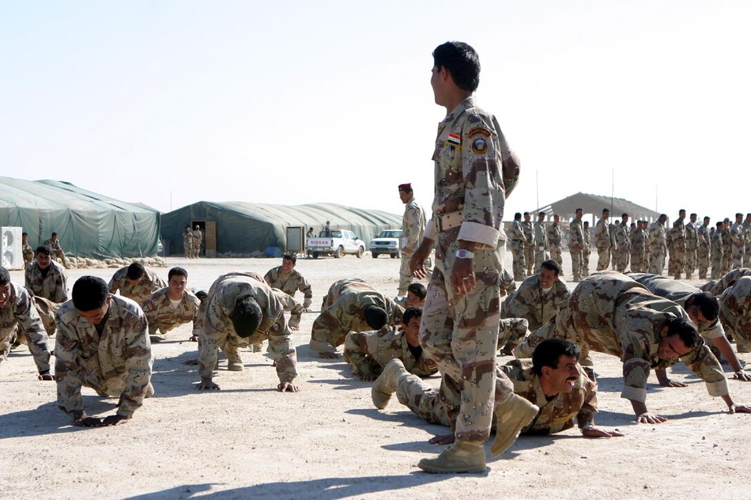 CAMP FALLUJAH, IRAQ -- Iraqi Security Force members do pushups while their commanding officer talks to them.  The ISF soldiers conduct their physical training in a similar manner to that of the Marines.  Official U.S. Marine Corps photo by Lance Cpl. Athanasios L. Genos