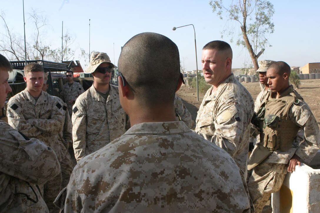 CAMP FALLUJAH, IRAQ -- Getting ready before the days mounted patrol through the battalion's area of operation, Cheif Warrant Officer 2 Jonothan Rabbert, Battalion Gunner, explains the rules of the road.  He takes the time to explain all the moving parts to the days trip ensuring the safe return of all the Marines.  Official U.S. Marine Corps photo by Lance Cpl. Athanasios L. Genos