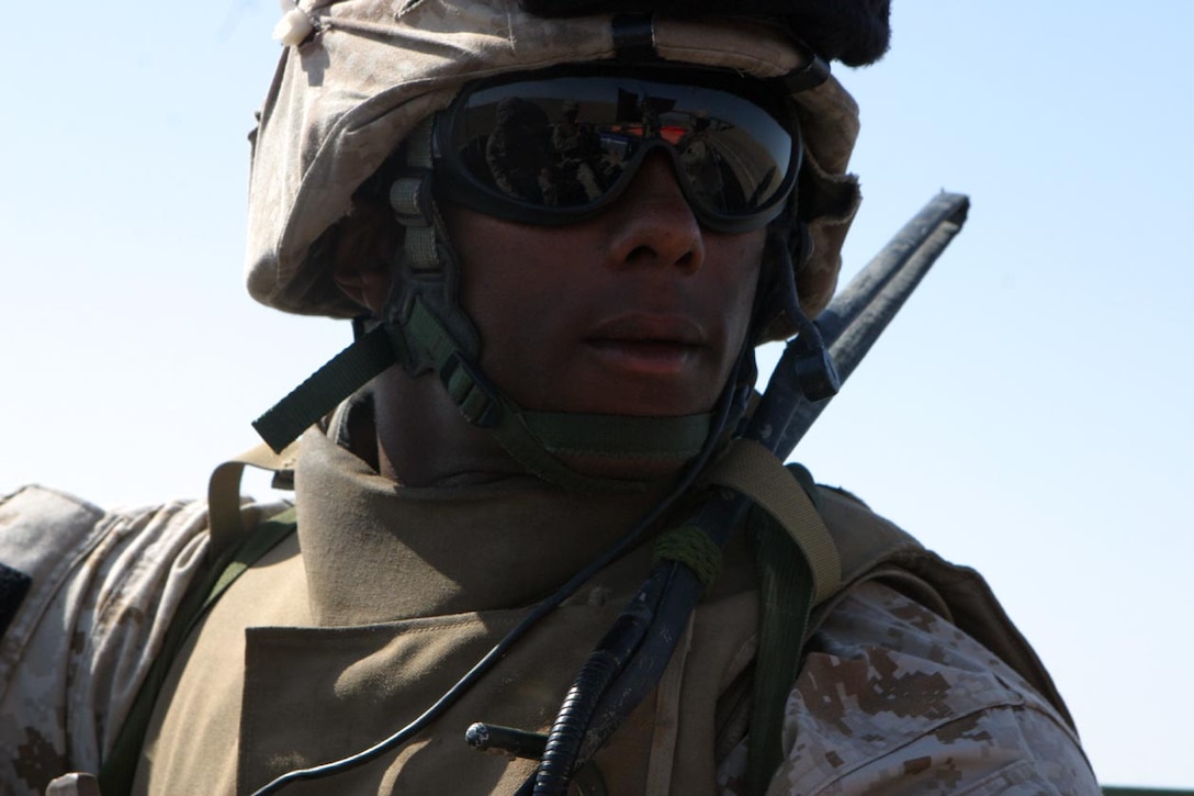 CAMP FALLUJAH, IRAQ -- Sitting in the back of the vehicle, Lance Cpl. Juan T. O'Neal waits for the patrol to stop and Maj. Larry Miller, Battalion Executive Officer to get out and begin moving by foot.  O'Neal is one of the Marines who works on the Personal Security Detachment when the XO goes out.  Official U.S. Marine Corps photo by Lance Cpl. Athanasios L. Genos