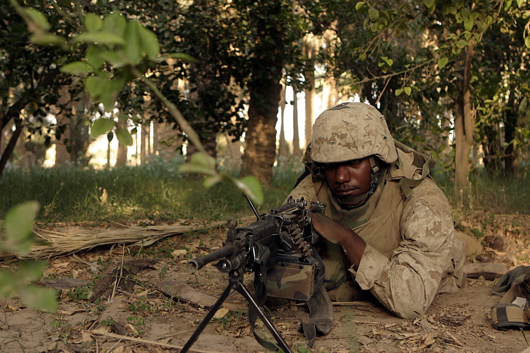 Haditha, Al Anbar, Iraq (May 26 2005) - SAW gunner Lance Cpl. Jeremy T. Dunlap , a 18-year-old Cleveland native, with 3/25, Kilo company sights in on a potential target during a recent mission.  (Official USMC photo by Cpl. Ken Melton)