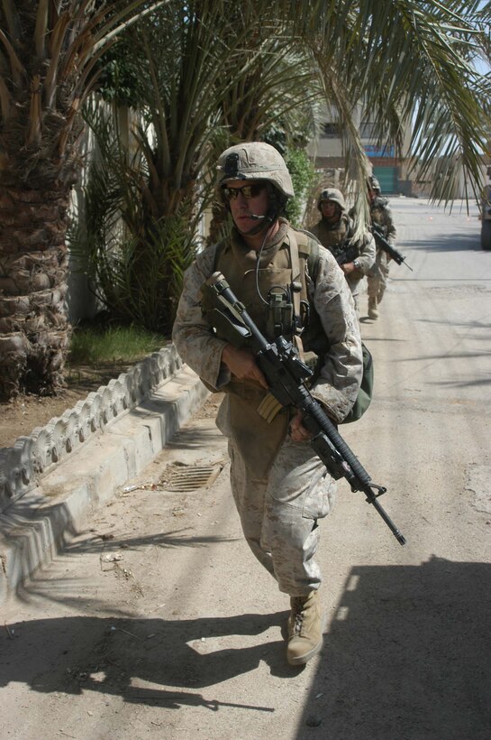 AR RAMADI, Iraq (June 2, 2005) - Lance Cpl. Tony Leal, a rifleman and team leader with 3rd Squad, 4th Platoon, Company A, 1st Battalion, 5th Marine Regiment, runs down a street here during a mission with his fellow Marines. The 24-year-old from Staford, Texas, is on his second deployment to Iraq supporting Operation Iraqi Freedom. Leal is a 2003 graduate of Sam Houston State University, Huntsville, Texas, and holds an Associates degree in criminal justice. Photo by: Cpl. Tom Sloan