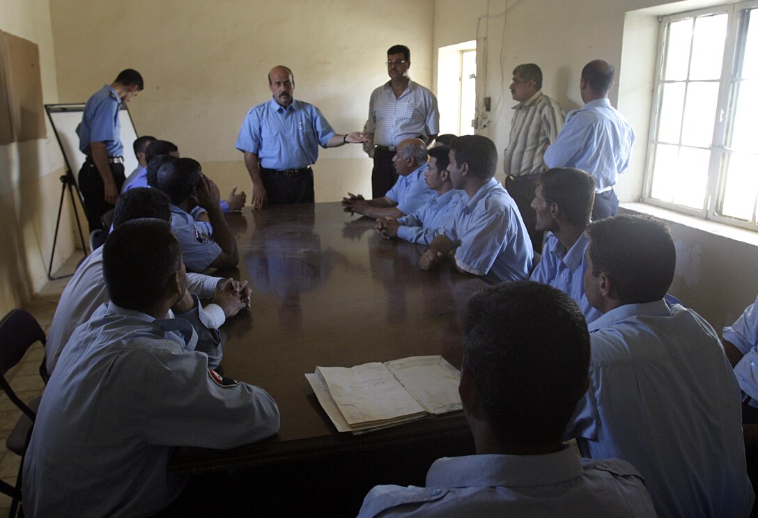 SAQLAWIYAH, Iraq - Iraqi policemen meet inside Saqlawiyah's police station recently to discuss security concerns.  Saqlawiyah had no police force until several months ago, when U.S. Marines helped facilitate their entry back into the city.  Currently, the policemen patrol the rural township's streets to maintain civil order and acquaint themselves with the citizens, as Marines continue to train them on community policing and public relations skills.