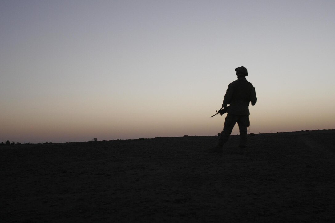 Barwana, Iraq (October 9, 2005)-- A Marine from 2nd platoon, Weapons company, 1st stands watch over a hidden bunker site until it can be excavated in the morning. (Official USMC Photo by Corporal Ken Melton)