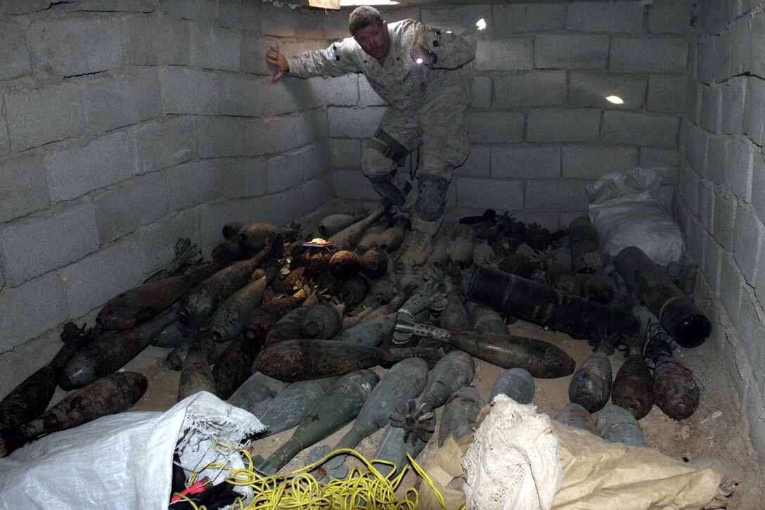 Barwana, Iraq (October 9, 2005)-- 1st James P. Donovan, combat engineer officer and East Point, Ga., native with 1st CEB attached to 1st LAR plan shines light over a massive underground cache find during Operation Rivergate.  (Official USMC Photo by Corporal Ken Melton)
