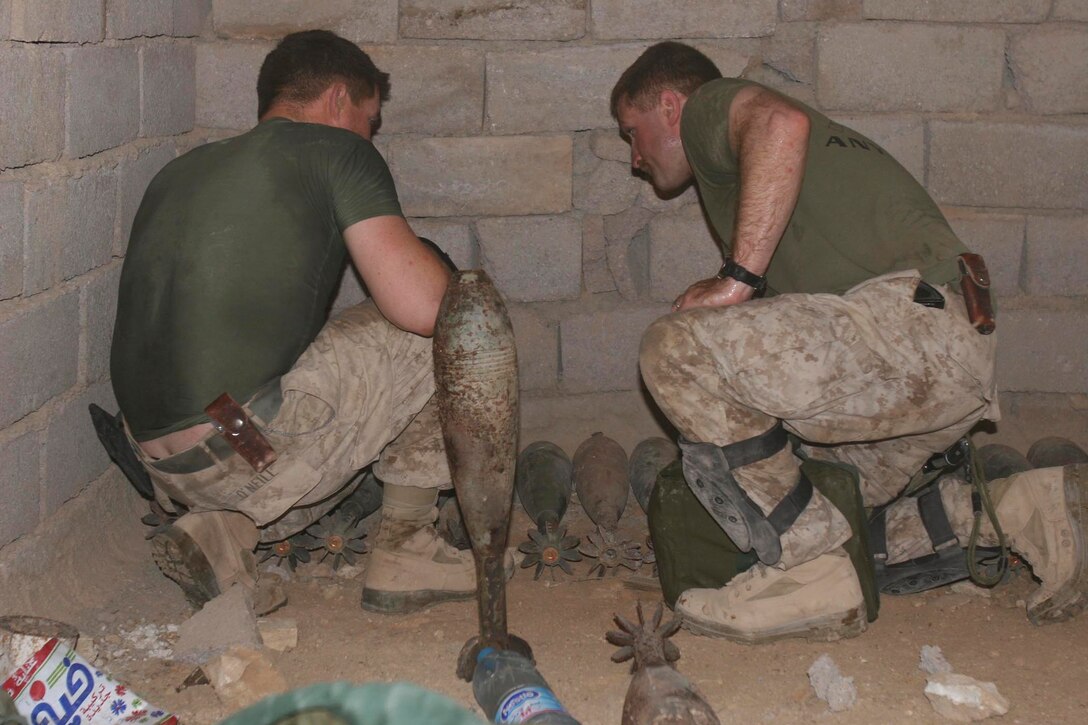 Barwana, Iraq (October 9, 2005)-- Pfc. Michael D. O'Neill and 1st James P. Donovan, combat engineers with 1st CEB attached to 1st LAR plan how to best place the ordnance so it can be destroyed.  (Official USMC Photo by Corporal Ken Melton)