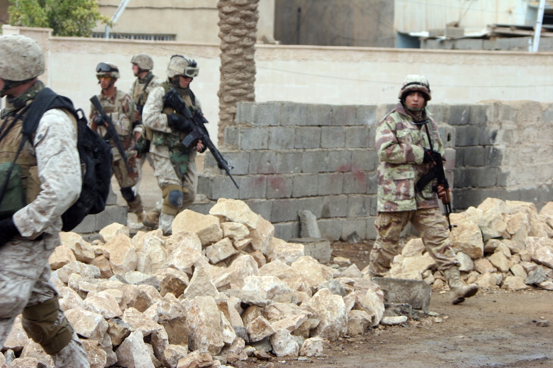 AR RAMADI, Iraq (November 16, 2005) - Marines with I Company, 3rd Battalion, 7th Marine Regiment, and soldiers from the local Iraqi Army patrol through the streets of Ar Ramadi Nov. 16. The patrol was one of the first joint patrols to be planned and executed almost entirely by the IA. Photo by Cpl. Shane Suzuki