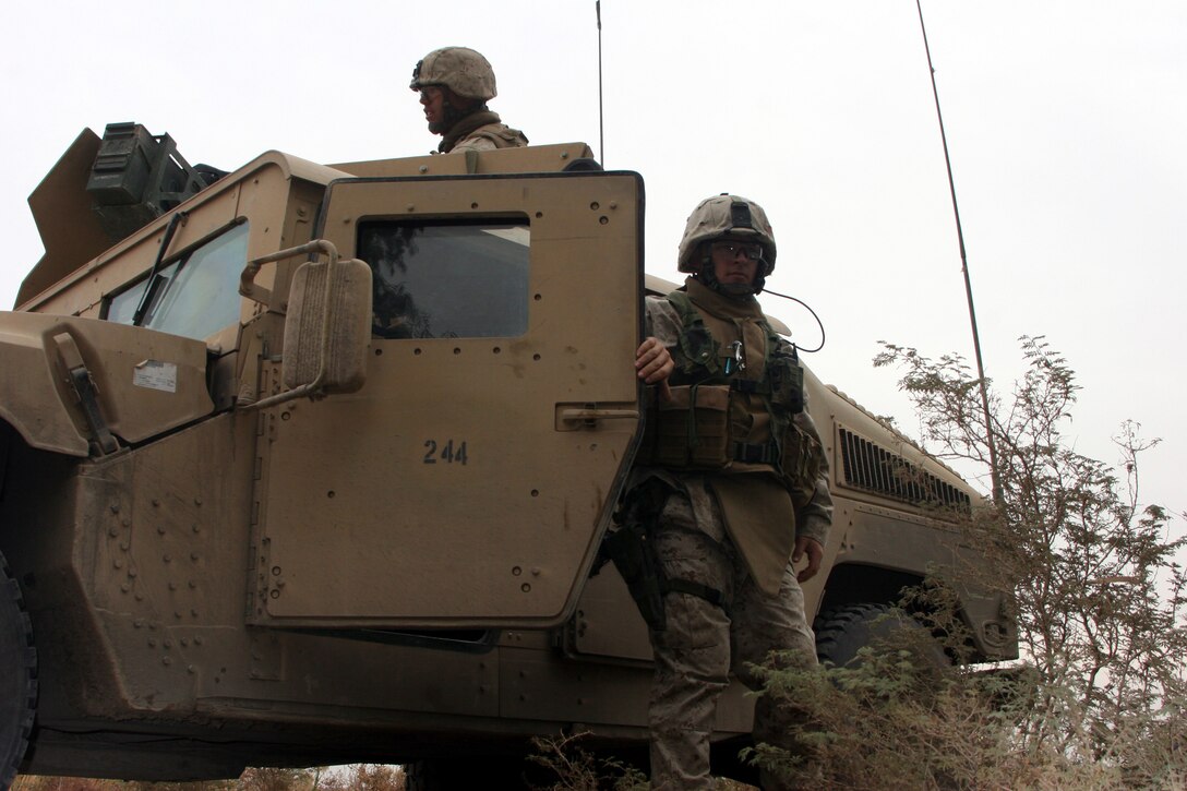 AR RAMADI, Iraq (November 20, 2005) - Corporal Dusty Sampson, an infantryman with Company I, steps out of his Humvee during Operation Machete Nov. 20. The Marines of 3rd Battalion, 7th Marine Regiment and 1st Combat Engineers Battalion discovered the largest weapons cache in more than six months during the mission. Photo by Cpl. Shane Suzuki